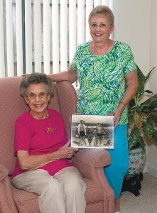 Staff photo by Emmy Errante. Silvey Robinson and Linda Robinson hold a photograph of Cecil and Ennis Robinson taken at Wrightsville Beach in 1939.