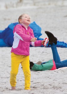 Staff photo by Emmy Errante. Four-year-old Lily Sullivan flies her new kite at Wrightsville Beach during the Cape Fear Kite Festival Sunday, Nov 9.