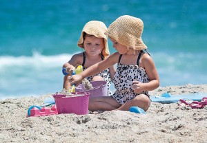 Camilla and Cassia Bereza play in the sand at Wrightsville Beach Aug. 30, Labor Day weekend.
