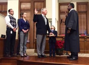 Staff photo by Cole Dittmer. District Judge James H. Faison III administers an oath of office to New Hanover County Commissioner Rob Zapple Dec. 22.