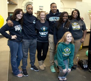 Students model clothing featuring the new athletic logo.