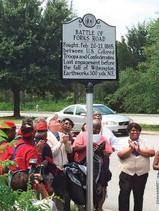 Staff photo by Pam Creech. Willie Black, right, vice chairman of the Commission on African-American History, local elected officials and historians unveil a new historical marker commemorating the Battle of Forks Road at the intersection of South 17th Street and Museum Drive Friday, June 19.