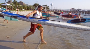 Participants in the June 23 Sunset SUP races run into the water at the Blockade Runner.