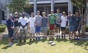 Boy Scout Troop 13 stands in front of the retaining wall they started building behind Wrightsville Beach's public safety building July 9.
