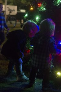 Jacob Lewis, 1, says hello to a new friend by the newly lit tree in Wrightsville Beach Park on Friday evening.