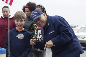 10-year-old John Spinosa, left, with Phil Kraus outside the United States Coast Guard booth at the Festival in the Park on Saturday.